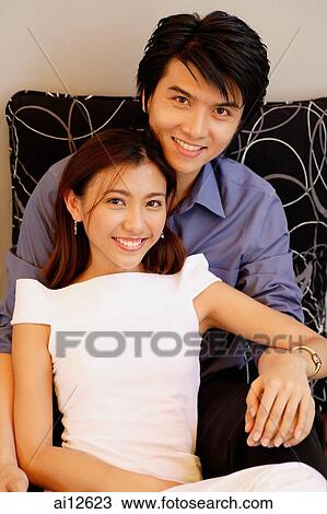 Stock Image - Couple looking at camera, portrait. Fotosearch