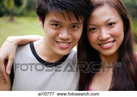 Couple looking at camera, portrait View Large Photo Image Stock Photo - Couple looking at camera, portrait. Fotosearch