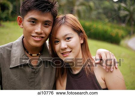 Couple looking at camera, portrait View Large Photo Image Stock Photograph - Couple looking at camera, portrait. Fotosearch