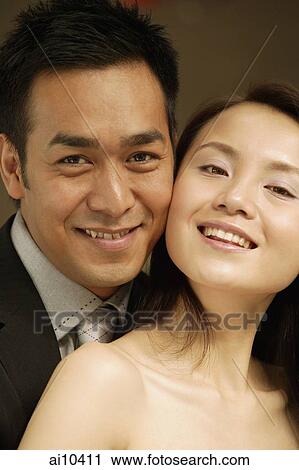 Couple looking at camera, smiling, portrait View Large Photo Image Stock Image - Couple looking at camera, smiling, portrait. Fotosearch