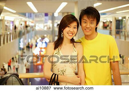 Stock Photo - Couple looking at camera, smiling. Fotosearch