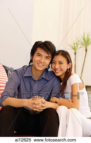 Couple looking at camera, smiling View Large Photo Image Stock Photography - Couple looking at camera, smiling. Fotosearch