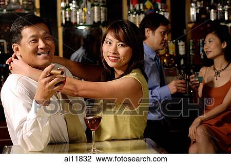 Couple looking at camera, woman hugging man View Large Photo Image Stock Image - Couple looking at camera, woman hugging man. Fotosearch