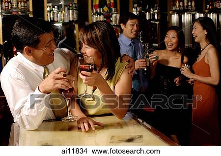 Couple looking at each other, holding wine glasses View Large Photo Image Picture - Couple looking at each other, holding wine glasses. Fotosearch