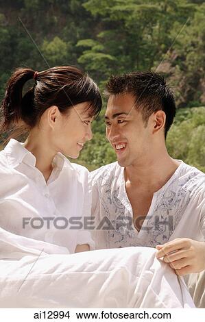 Couple looking at each other View Large Photo Image Picture - Couple looking at each other. Fotosearch