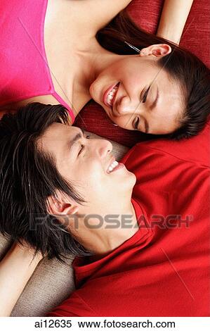 Stock Photography - Couple lying face to face.. Fotosearch