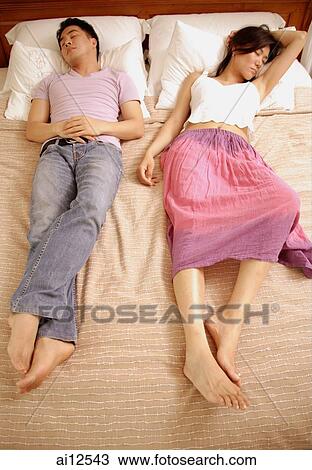 Couple lying in bed, side by side View Large Photo Image Stock Image - Couple lying in bed, side by side. Fotosearch