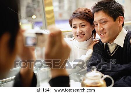 Couple posing as another person takes their picture View Large Photo Image Stock Image - Couple posing as another person takes their picture. Fotosearch