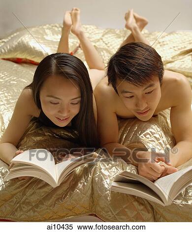 Couple reading on bed. View Large Photo Image Stock Photography - Couple reading on bed.. Fotosearch