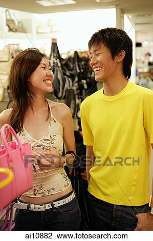 Couple shopping, woman holding a bag View Large Photo Image Stock Image - Couple shopping, woman holding a bag. Fotosearch