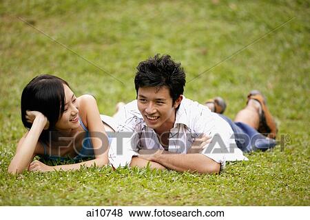 Couple side by side on the grass View Large Photo Image Stock Photo - Couple side by side on the grass. Fotosearch
