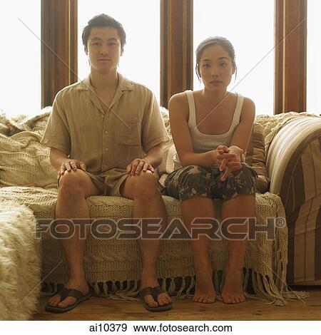 Couple sitting apart, home interior View Large Photo Image Stock Photo - Couple sitting apart, home interior. Fotosearch