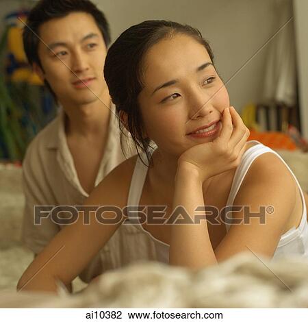 Couple sitting apart, woman with hand on chin View Large Photo Image Stock Image - Couple sitting apart, woman with hand on chin. Fotosearch