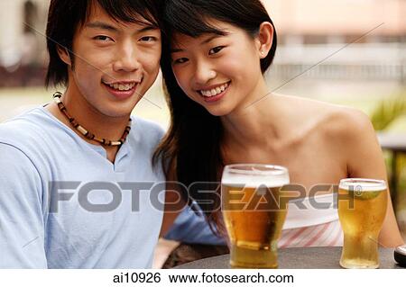 Couple sitting at cafe, cheek to cheek, looking at camera View Large Photo Image Stock Photograph - Couple sitting at cafe, cheek to cheek, looking at camera. Fotosearch