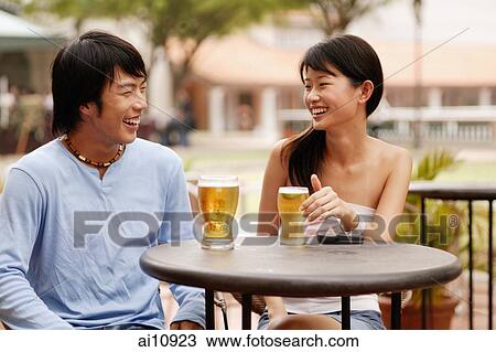 Couple sitting at cafe View Large Photo Image Stock Image - Couple sitting at cafe. Fotosearch