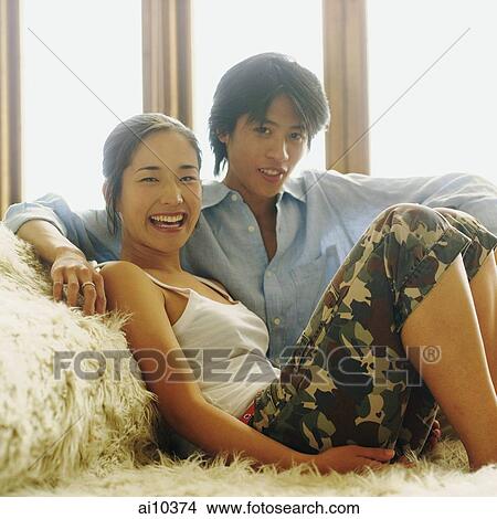 Couple sitting by a window, looking at camera View Large Photo Image Picture - Couple sitting by a window, looking at camera. Fotosearch