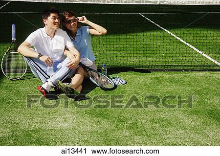 Couple sitting down on tennis court, side by side View Large Photo Image Stock Image - Couple sitting down on tennis court, side by side. Fotosearch