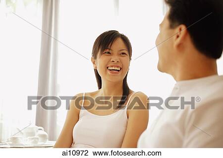 Couple sitting down side by side, face to face View Large Photo Image Stock Image - Couple sitting down side by side, face to face. Fotosearch