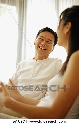 Couple sitting down side by side, talking View Large Photo Image Picture - Couple sitting down side by side, talking. Fotosearch