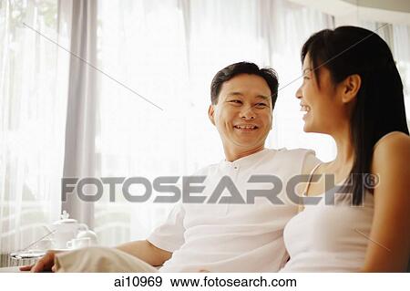 Couple sitting down side by side, talking View Large Photo Image Stock Photo - Couple sitting down side by side, talking. Fotosearch