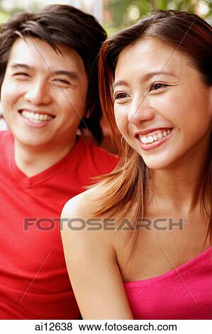 Couple sitting side by side, toothy smiles View Large Photo Image Stock Photo - Couple sitting side by side, toothy smiles. Fotosearch