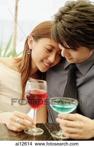 Picture - Couple sitting side by side, woman leaning on man. Fotosearch