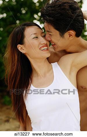Stock Photo - Couple smiling, portrait. Fotosearch