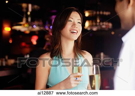 Couple standing face to face, holding drinks View Large Photo Image Stock Photo - Couple standing face to face, holding drinks. Fotosearch