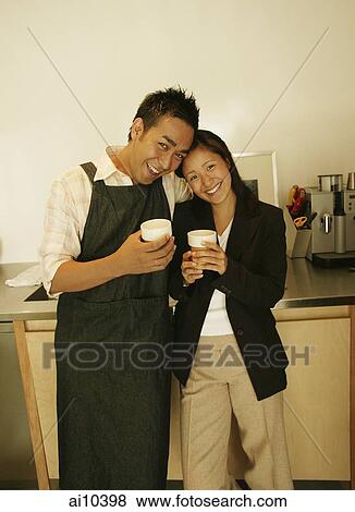 Couple standing in kitchen, side by side View Large Photo Image Stock Photo - Couple standing in kitchen, side by side. Fotosearch