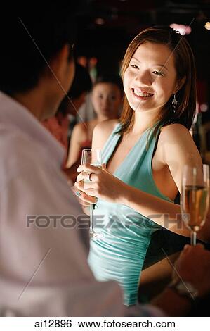 Stock Photograph - Couple talking at club. Fotosearch