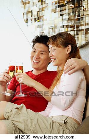 Couple toasting with champagne View Large Photo Image Stock Photo - Couple toasting with champagne. Fotosearch