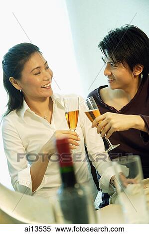 Stock Photography - Couple toasting with champagne. Fotosearch