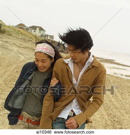 Couple walking along beach View Large Photo Image Stock Photograph - Couple walking along beach. Fotosearch