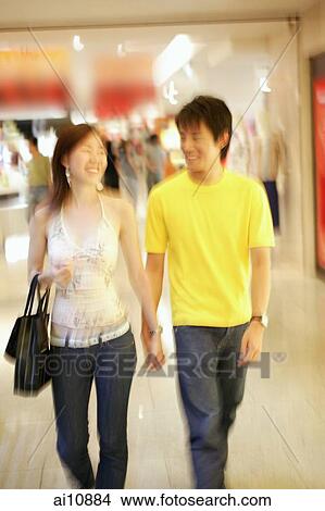 Picture - Couple walking hand in hand in store. Fotosearch