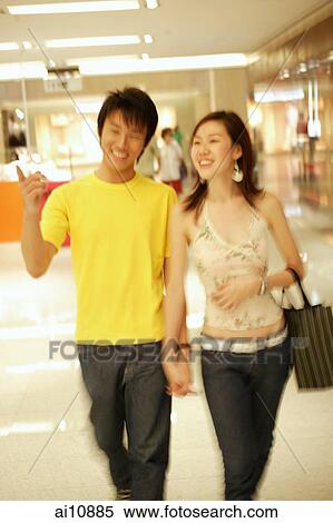 Couple walking hand in hand shopping View Large Photo Image Stock Photography - Couple walking hand in hand shopping. Fotosearch