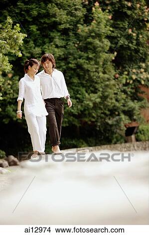 Couple walking in park View Large Photo Image Picture - Couple walking in park. Fotosearch