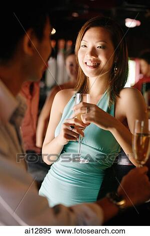 Couple with champagne glasses, talking View Large Photo Image Stock Photography - Couple with champagne glasses, talking. Fotosearch