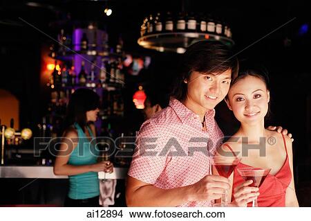 Couple with drinks, looking at camera, portrait View Large Photo Image Picture - Couple with drinks, looking at camera, portrait. Fotosearch