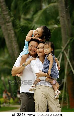 Couple with two daughters, looking away View Large Photo Image Stock Image - Couple with two daughters, looking away. Fotosearch