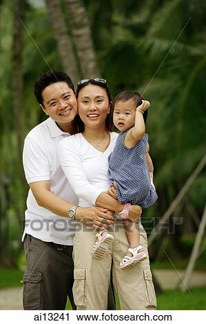 Stock Image - Couple with young daughter, portrait. Fotosearch