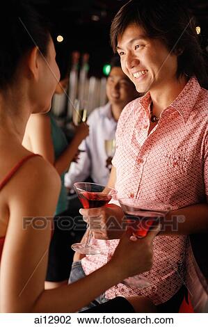 Couples at night club, talking, man facing camera View Large Photo Image Stock Image - Couples at night club, talking, man facing camera. Fotosearch