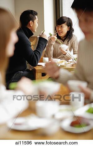 Couples eating at a restaurant View Large Photo Image Stock Photograph - Couples eating at a restaurant. Fotosearch