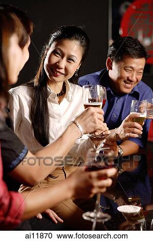 Couples having drinks at bar View Large Photo Image Stock Image - Couples having drinks at bar. Fotosearch