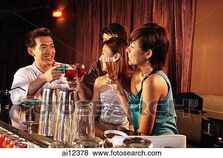 Stock Photo - Couples having drinks at bar. Fotosearch