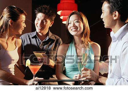 Couples in night club, holding drinks View Large Photo Image Stock Photo - Couples in night club, holding drinks. Fotosearch