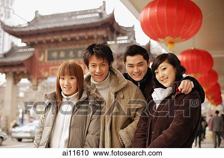 Stock Image - Couples posing, looking at camera. Fotosearch