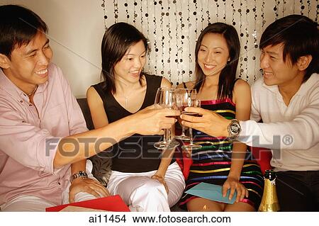 Couples sitting down raising wine glasses, toasting View Large Photo Image Picture - Couples sitting down raising wine glasses, toasting. Fotosearch