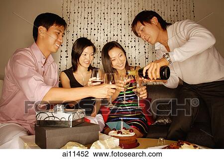Couples sitting down with wine glasses, man pouring wine. View Large Photo Image Stock Image - Couples sitting down with wine glasses, man pouring wine.. Fotosearch