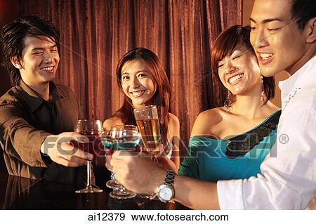 Couples toasting, woman looking at camera View Large Photo Image Stock Photo - Couples toasting, woman looking at camera. Fotosearch