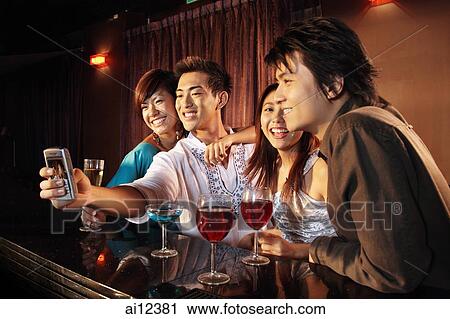 Couples using camera phone View Large Photo Image Stock Image - Couples using camera phone. Fotosearch